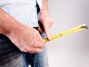 a man measures his penis length before soda augmentation